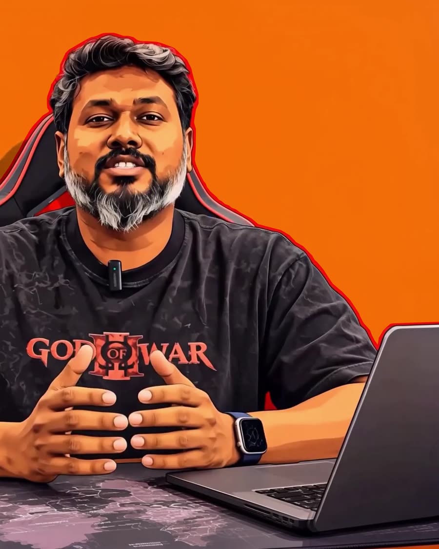 ESOWOLF at his desk, mid-explanation, orange studio wall behind